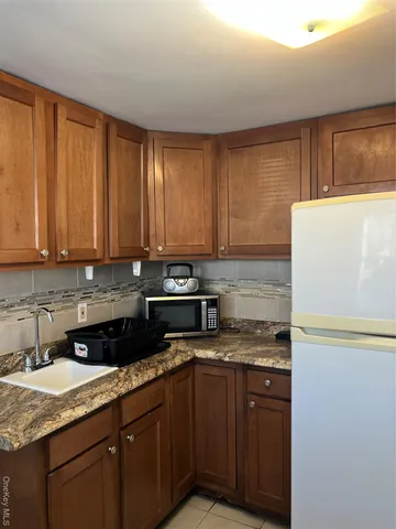 a kitchen with a sink and a refrigerator