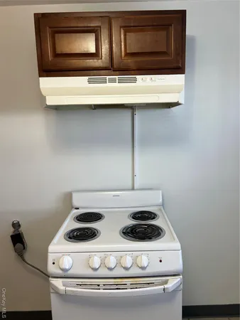 a stove top oven sitting inside of a kitchen