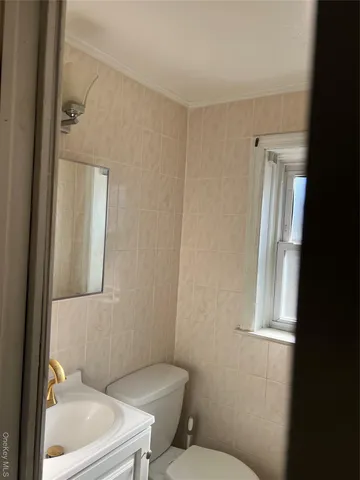 a white toilet sitting next to a bathroom sink