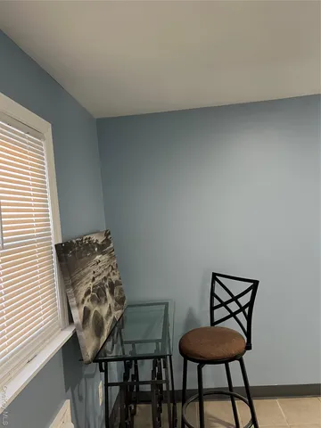 a view of a room that has a table and chair in it