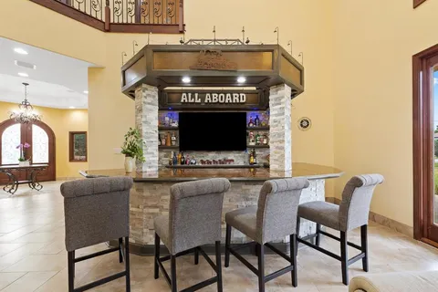 a kitchen with stainless steel appliances kitchen island granite countertop a refrigerator and a stove