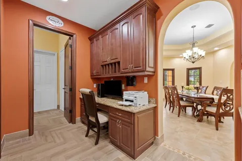 a view of a hallway with wooden floor and windows