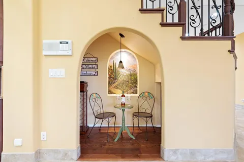 a bed sitting in a bedroom next to a window