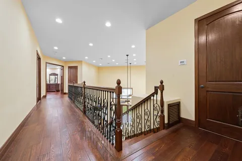 a bedroom with a bed and a large mirror next to a window