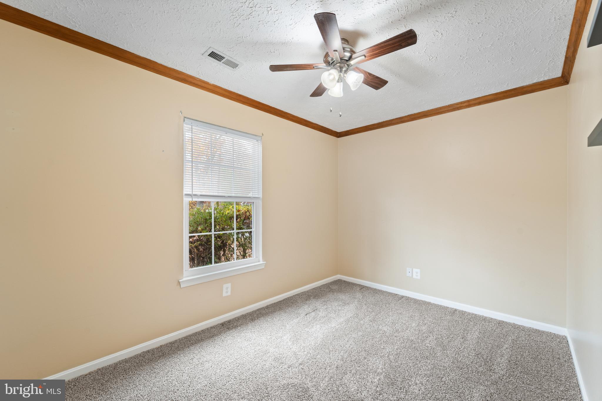 659 San Gabriel Road Lusby, MD 20657 - Photo 17 of 20 an empty room with a window and a ceiling fan