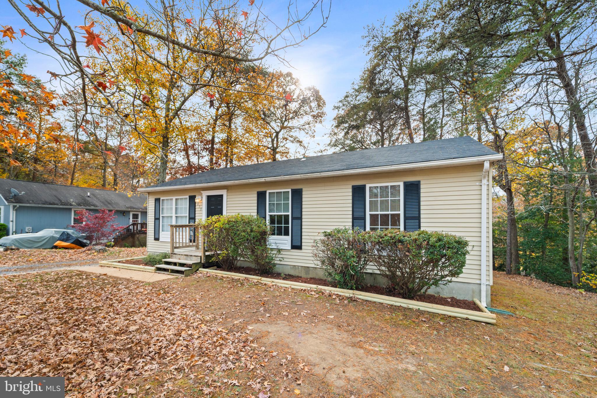 659 San Gabriel Road Lusby, MD 20657 - Photo 18 of 20 a front view of a house with a yard and potted plants