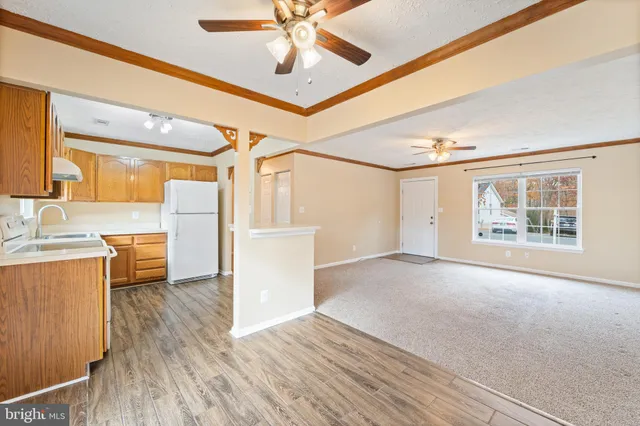 a view of a kitchen with wooden floor and a kitchen view