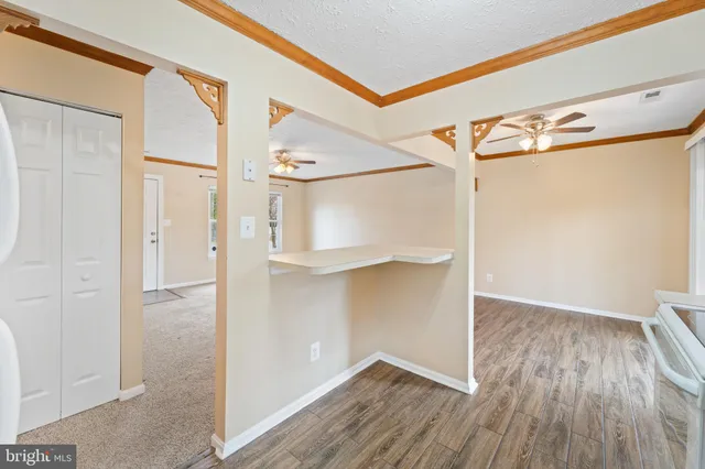 a view of walk in closet with wooden floor
