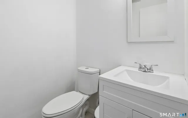 a white toilet sitting next to a white sink