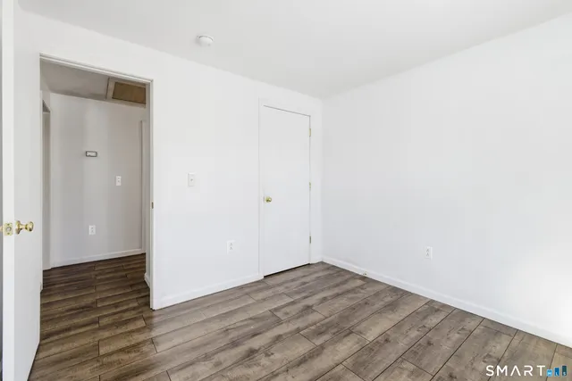 a view of a room with wooden floor