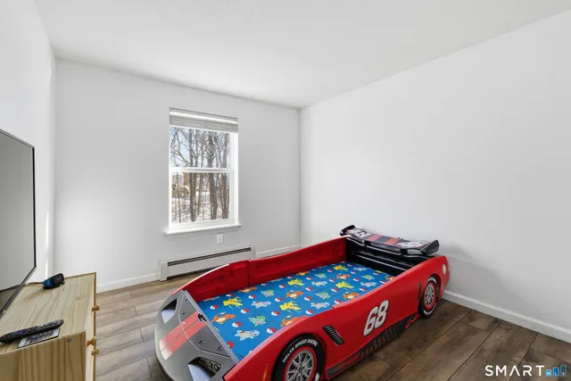 a bedroom with bed and a window