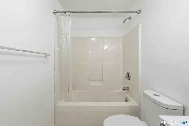 a bathroom with a shower and a toilet