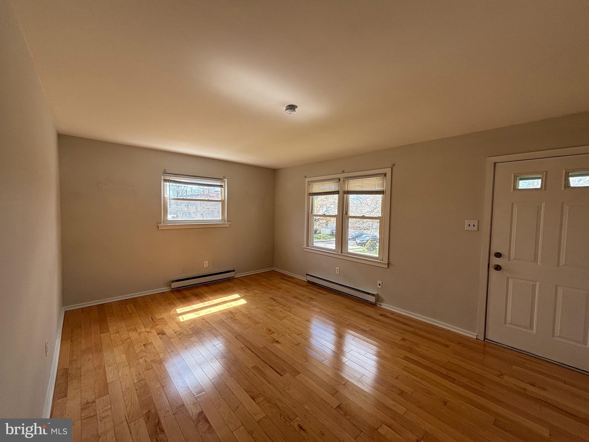 47 Walnut Street Ambler, PA 19002 - Photo 2 of 9 a view of an empty room with wooden floor and a window