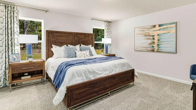 a bed sitting in a bedroom next to a window