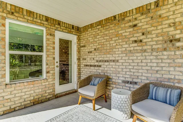 a outdoor living space with a couch and a window