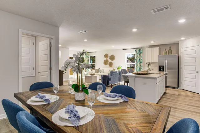 a open dining room with stainless steel appliances kitchen island granite countertop furniture and wooden floor