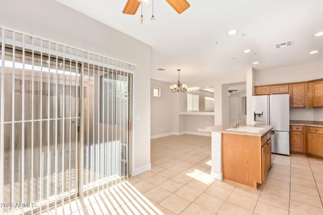 a kitchen with stainless steel appliances kitchen island granite countertop a refrigerator and a stove top oven