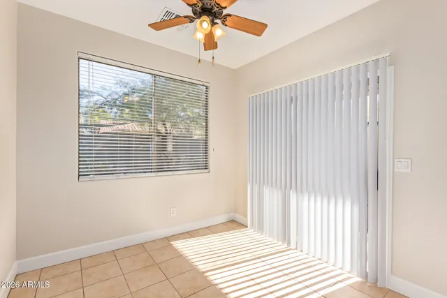 a view of a livingroom with a ceiling fan and window