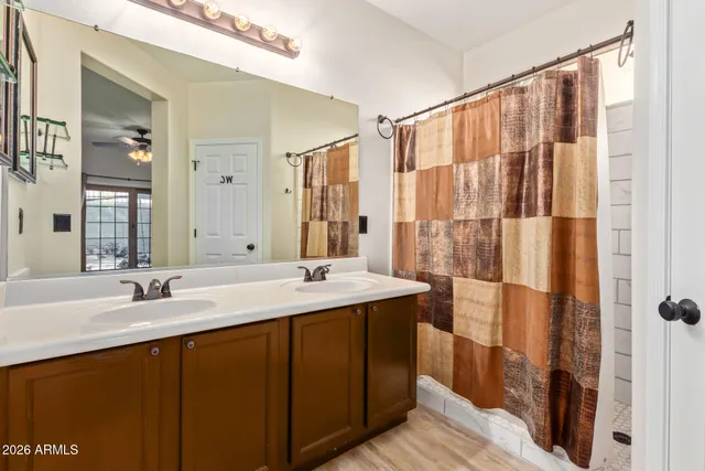 a bathroom with a double vanity sink and mirror