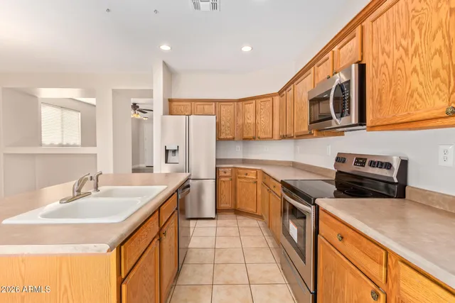 a kitchen with stainless steel appliances granite countertop a sink and a stove