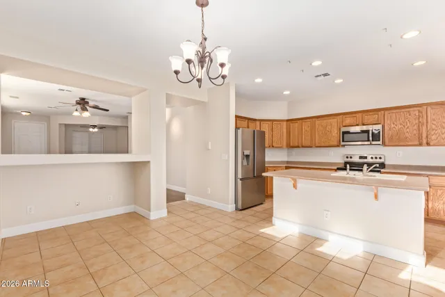 a kitchen with stainless steel appliances granite countertop a refrigerator and a stove top oven