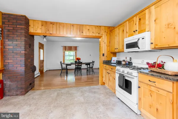 a kitchen with stainless steel appliances white cabinets and a stove top oven