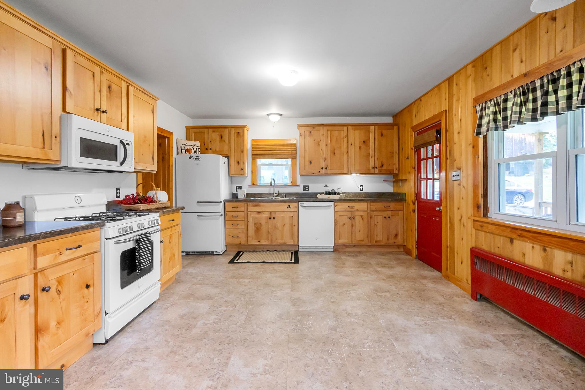 2485 Potomac Road Berkeley Springs, WV 25411 - Photo 13 of 60 a kitchen with stainless steel appliances granite countertop a stove a sink dishwasher and a refrigerator