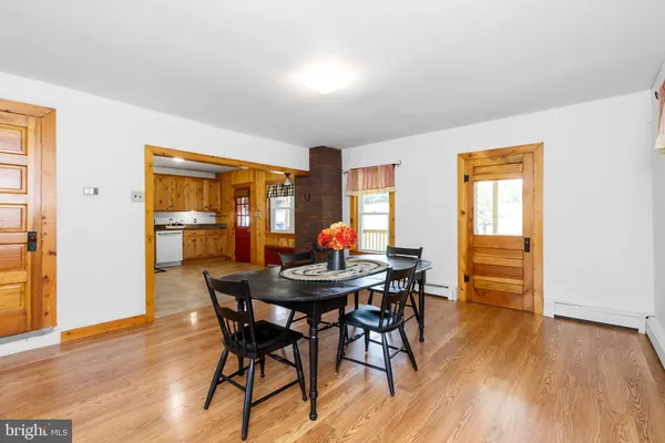 a view of a dining room with furniture and wooden floor