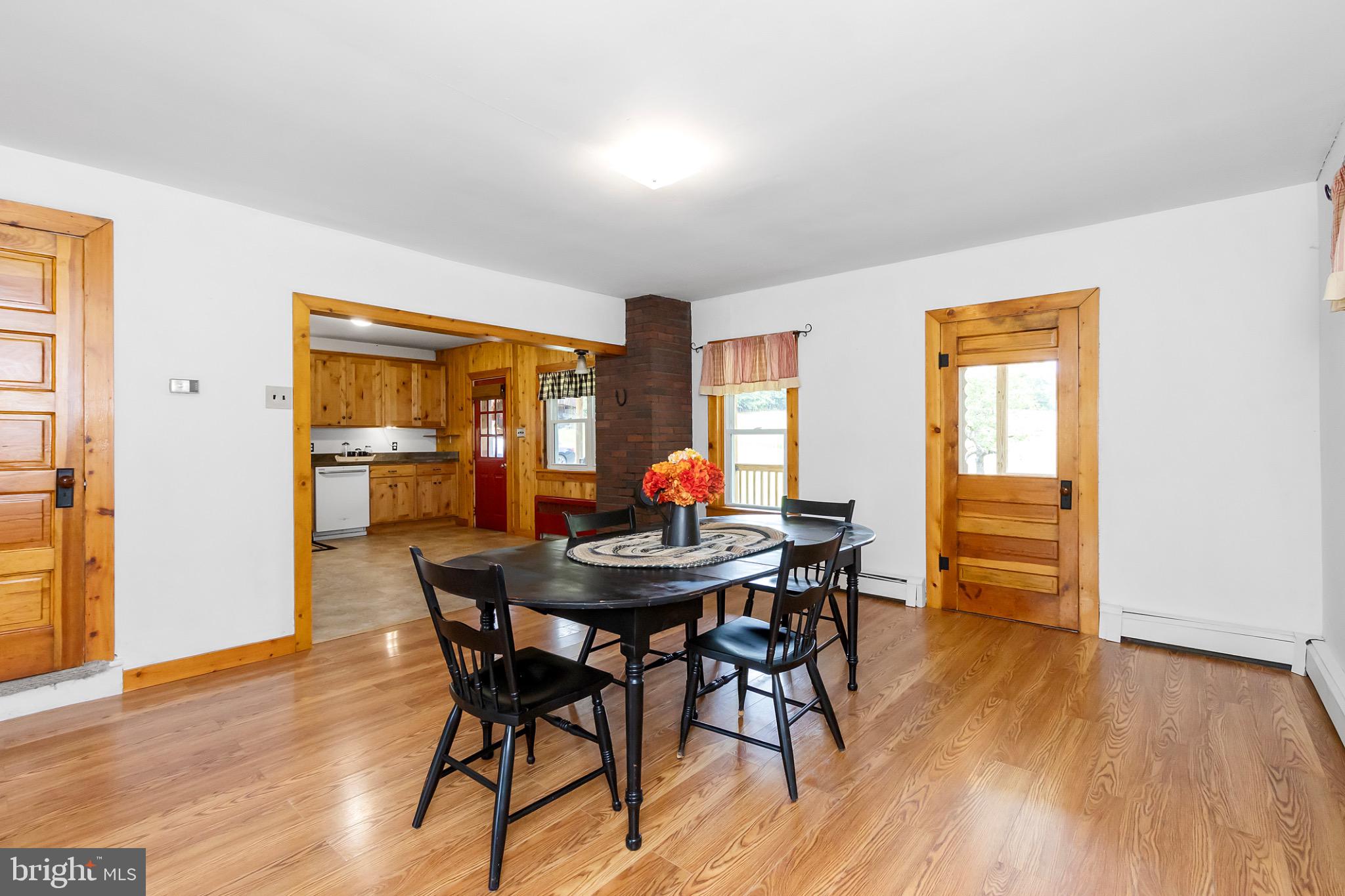2485 Potomac Road Berkeley Springs, WV 25411 - Photo 15 of 60 a view of a dining room with furniture and wooden floor