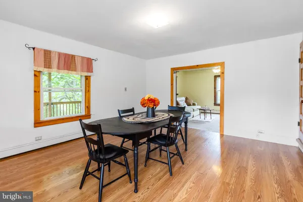 a view of a dining room with furniture window and wooden floor