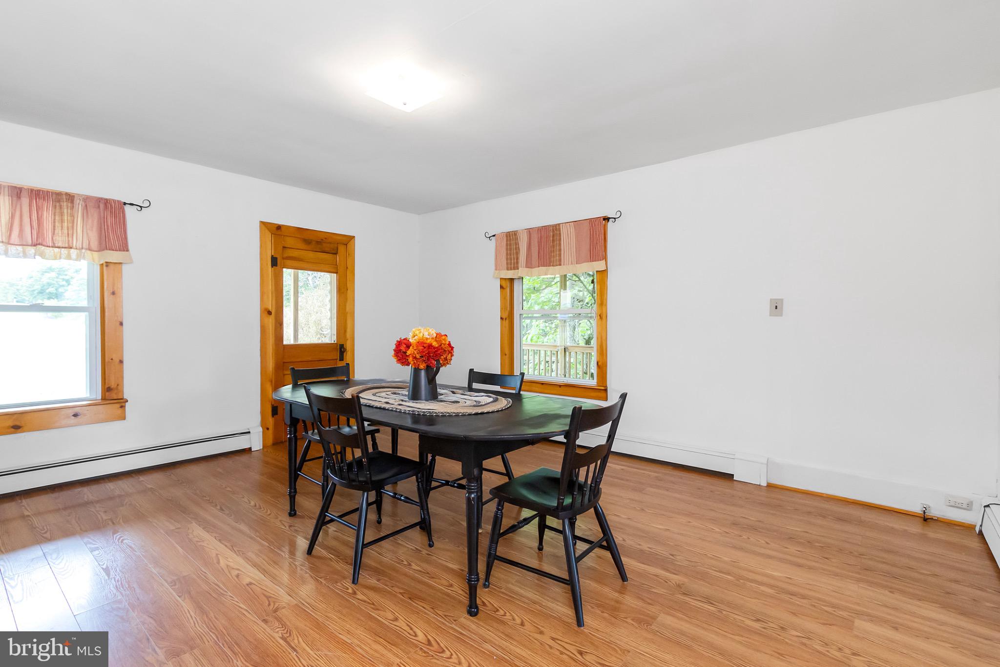 2485 Potomac Road Berkeley Springs, WV 25411 - Photo 17 of 60 a view of a dining room with furniture and wooden floor