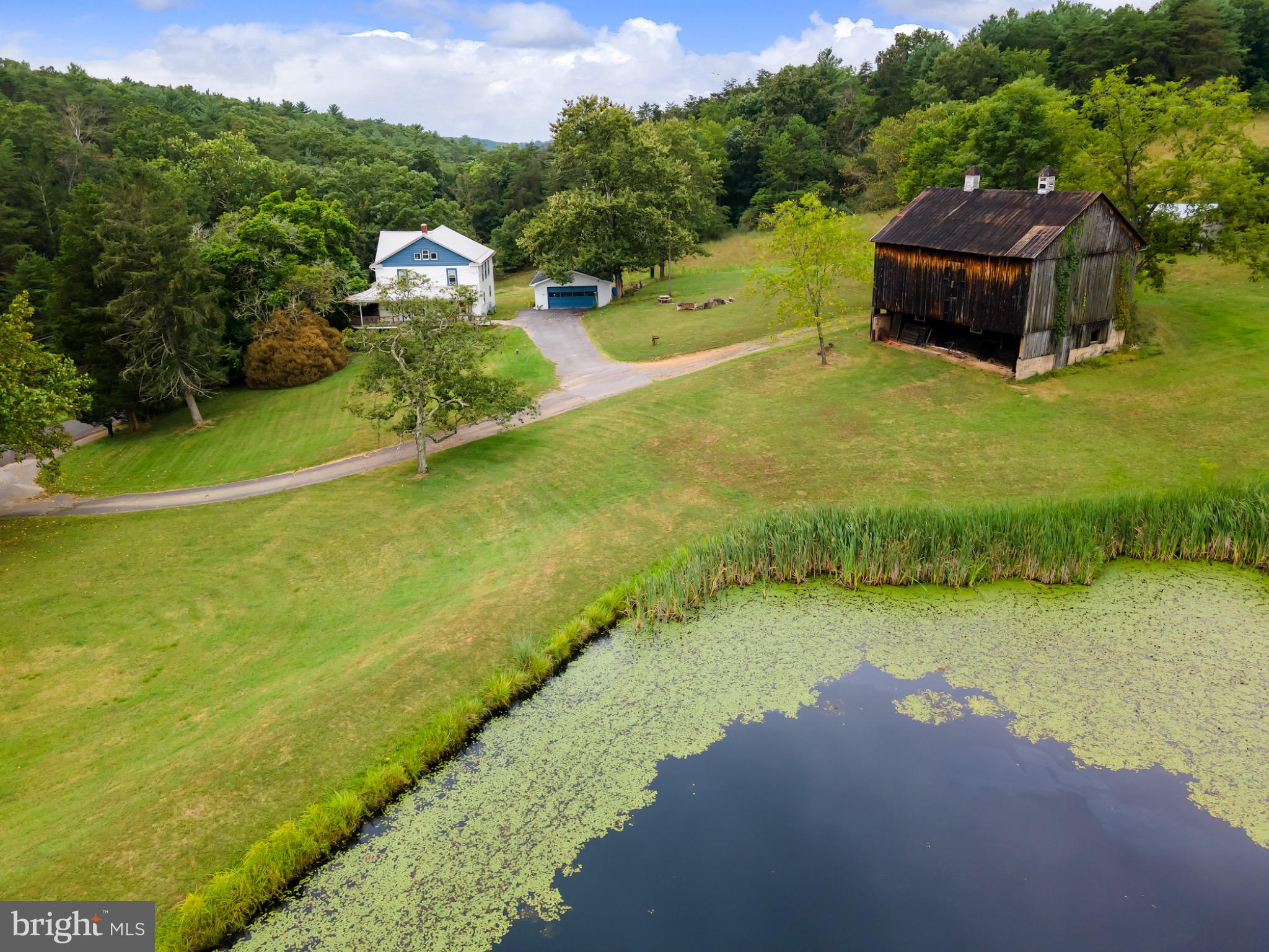 2485 Potomac Road Berkeley Springs, WV 25411 - Photo 2 of 60 a view of a lake with a yard