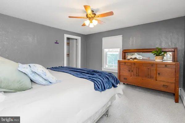 a bedroom with a bed and a painting on the wall