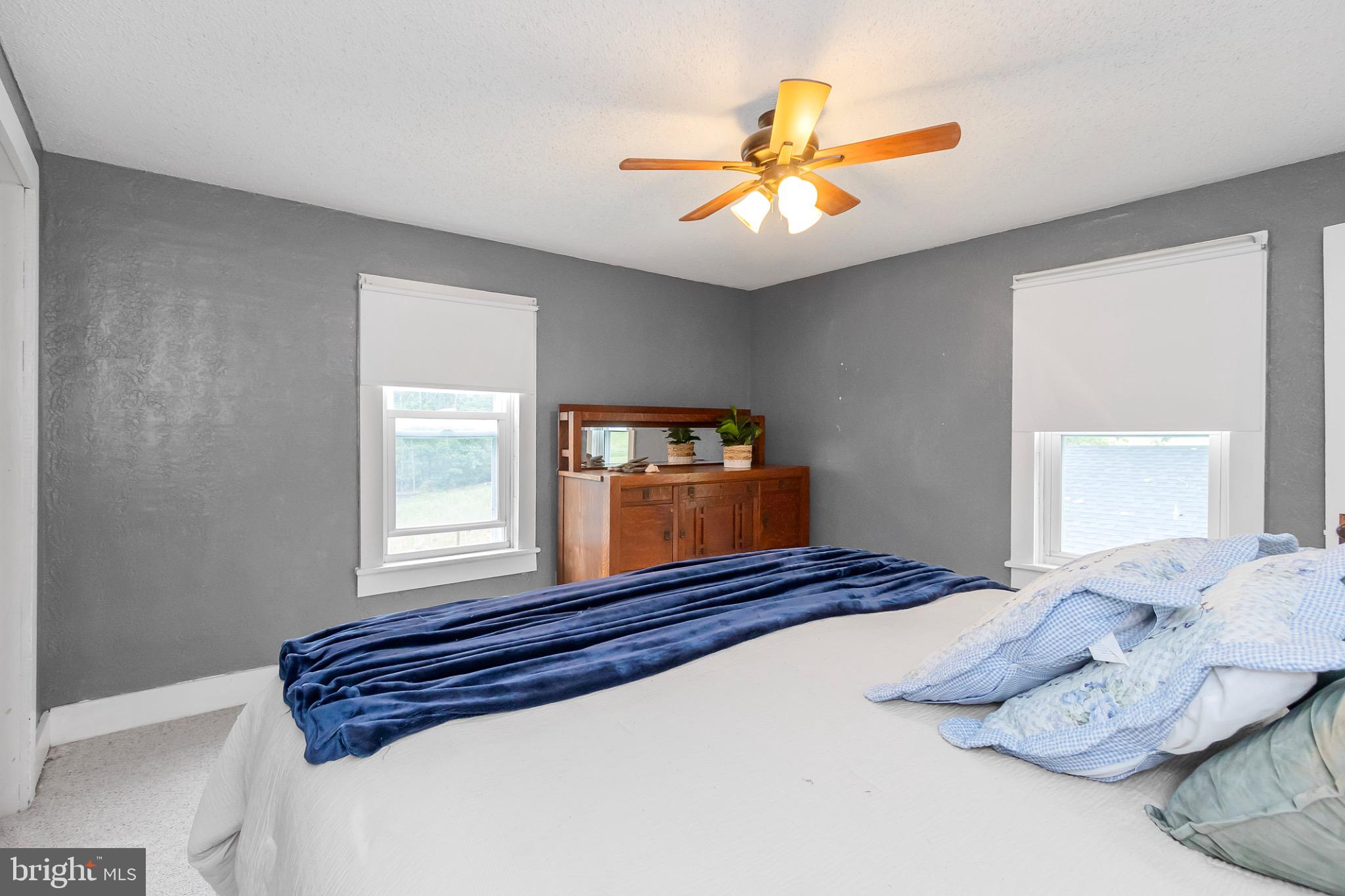 2485 Potomac Road Berkeley Springs, WV 25411 - Photo 31 of 60 a bedroom with a large bed and a window