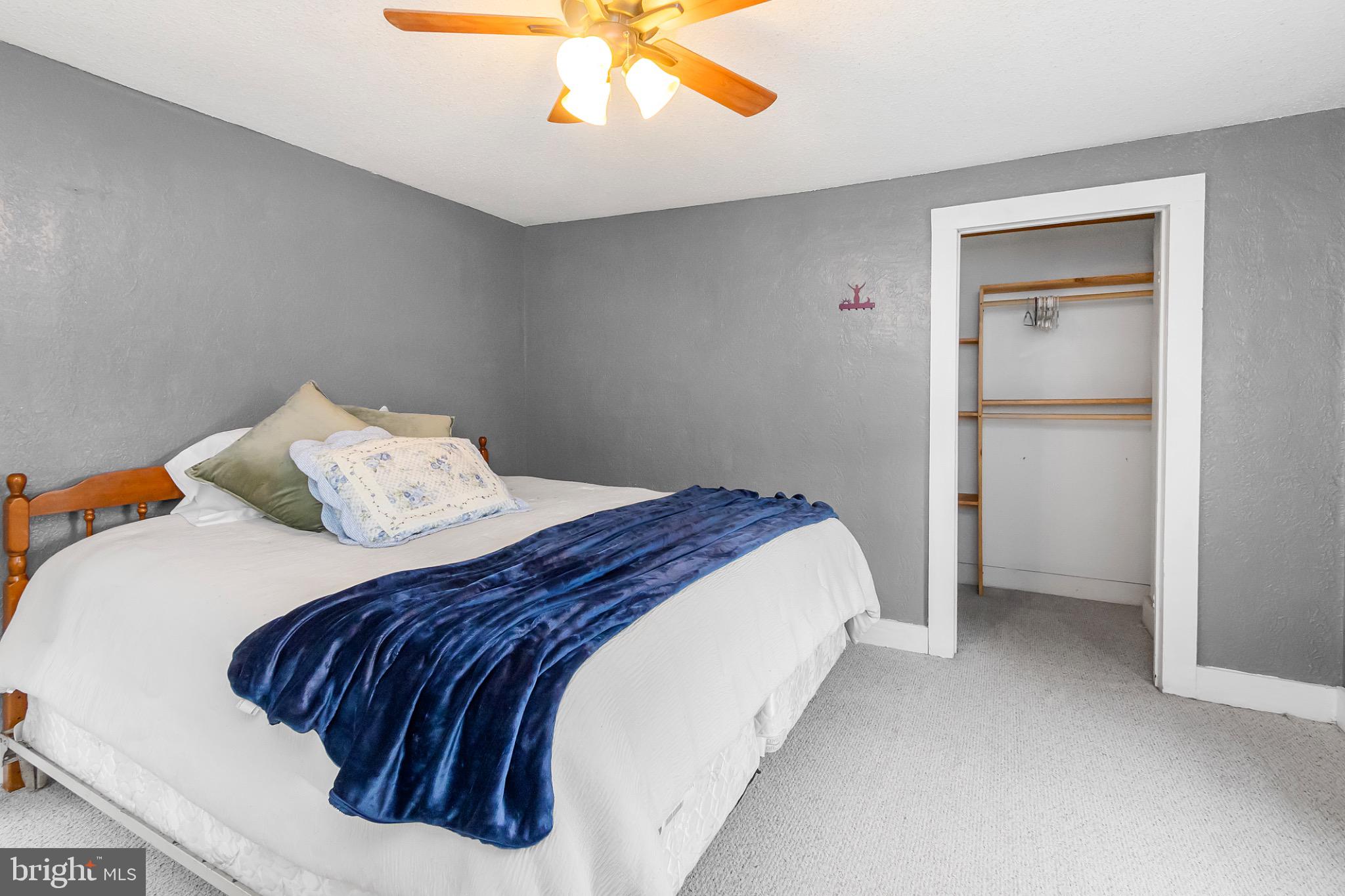 2485 Potomac Road Berkeley Springs, WV 25411 - Photo 32 of 60 a bedroom with a bed and lamp