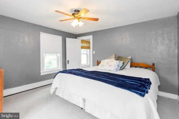 a bedroom with a bed and a ceiling fan