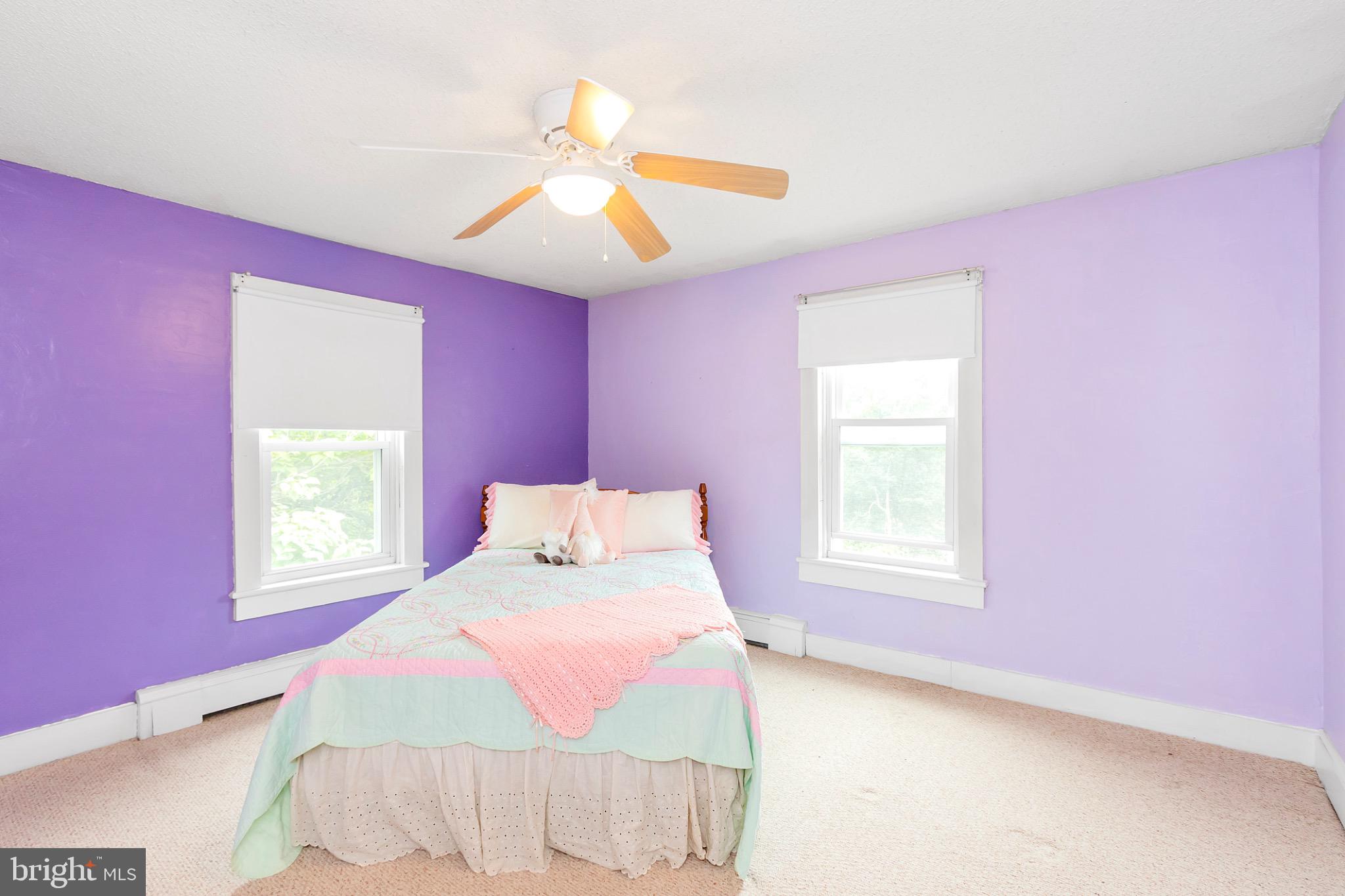 2485 Potomac Road Berkeley Springs, WV 25411 - Photo 34 of 60 a bedroom with a bed and a chandelier