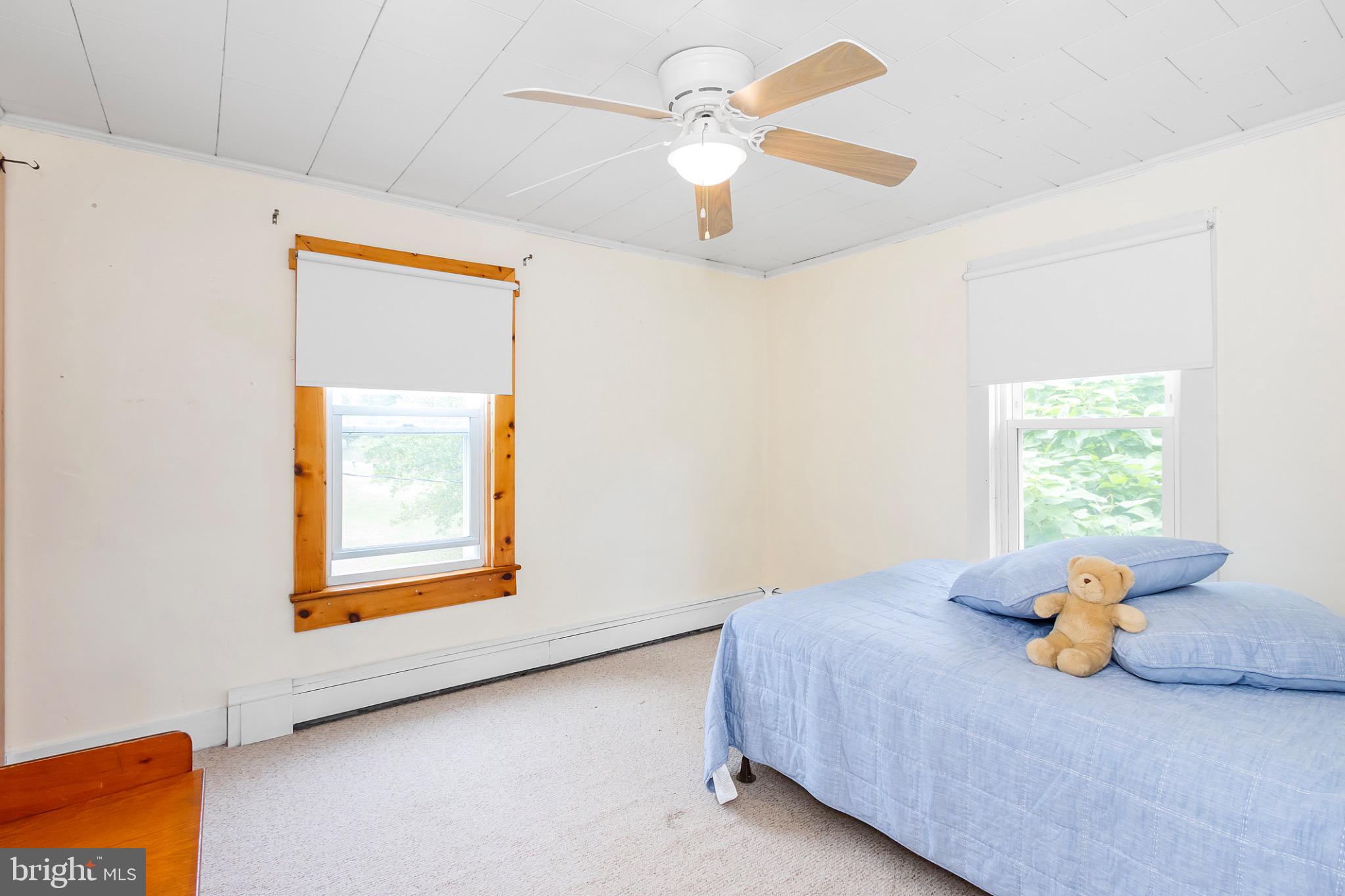 2485 Potomac Road Berkeley Springs, WV 25411 - Photo 39 of 60 a bedroom with a bed and a window