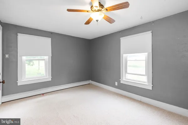 a view of hallway with stairs and a closet