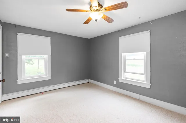 a view of hallway with stairs and a closet