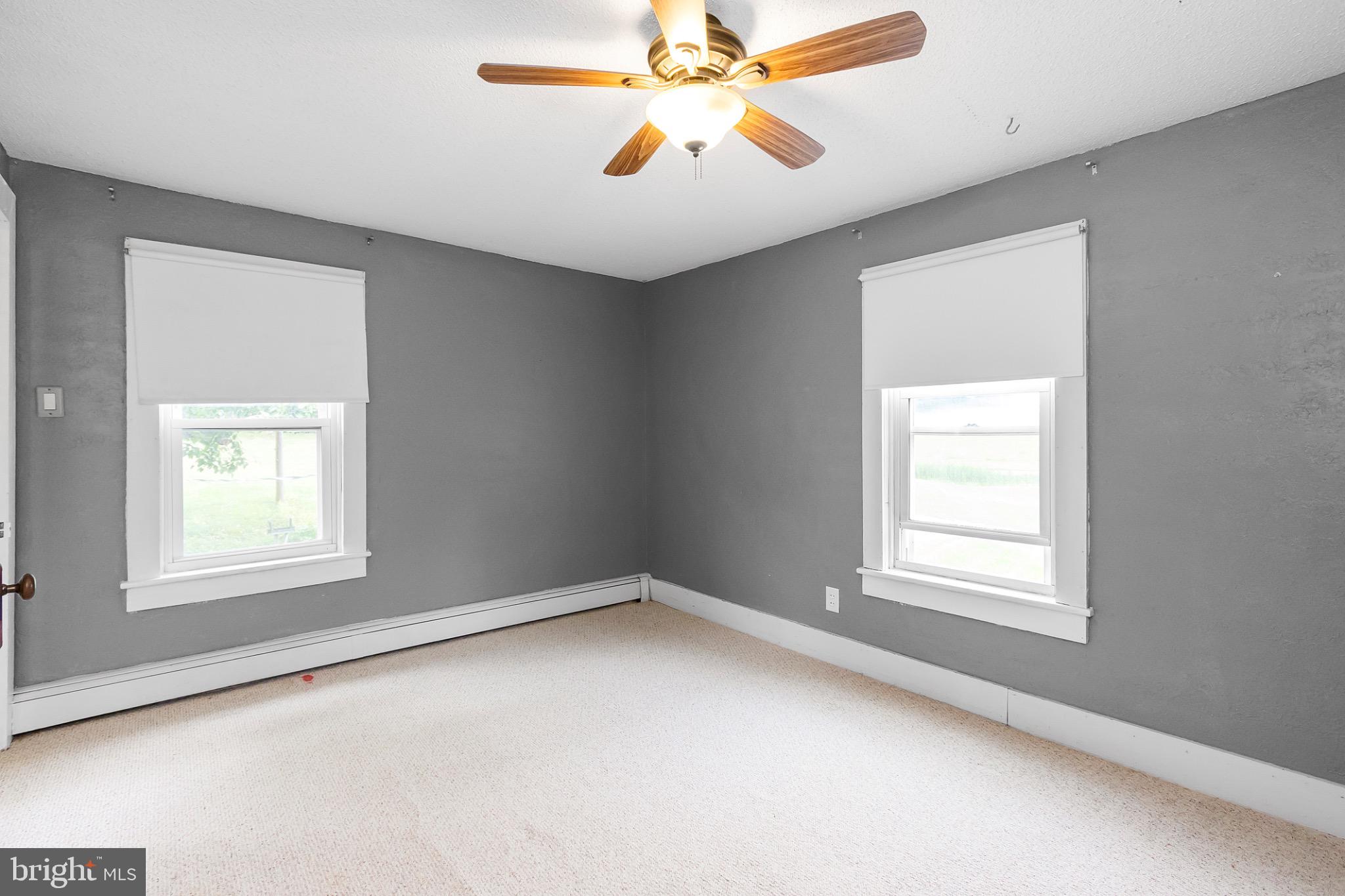 2485 Potomac Road Berkeley Springs, WV 25411 - Photo 40 of 60 an empty room with a window and a fan