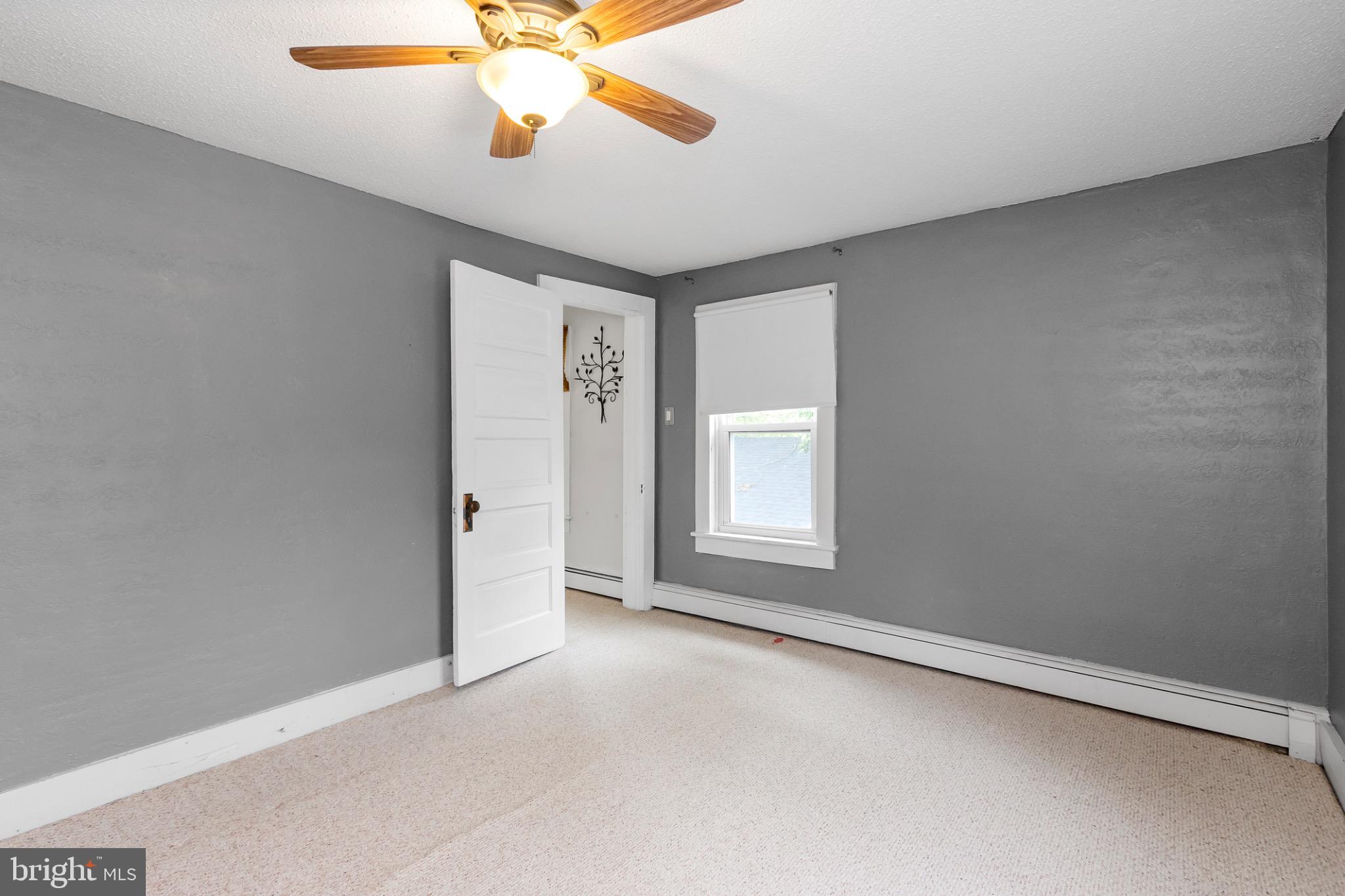 2485 Potomac Road Berkeley Springs, WV 25411 - Photo 42 of 60 an empty room with windows and fan