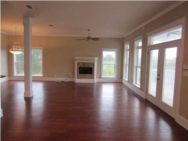 6272 Co Road Santa Rosa Beach, FL 32459 - Photo 2 of 19 a view of an empty room with wooden floor and a window