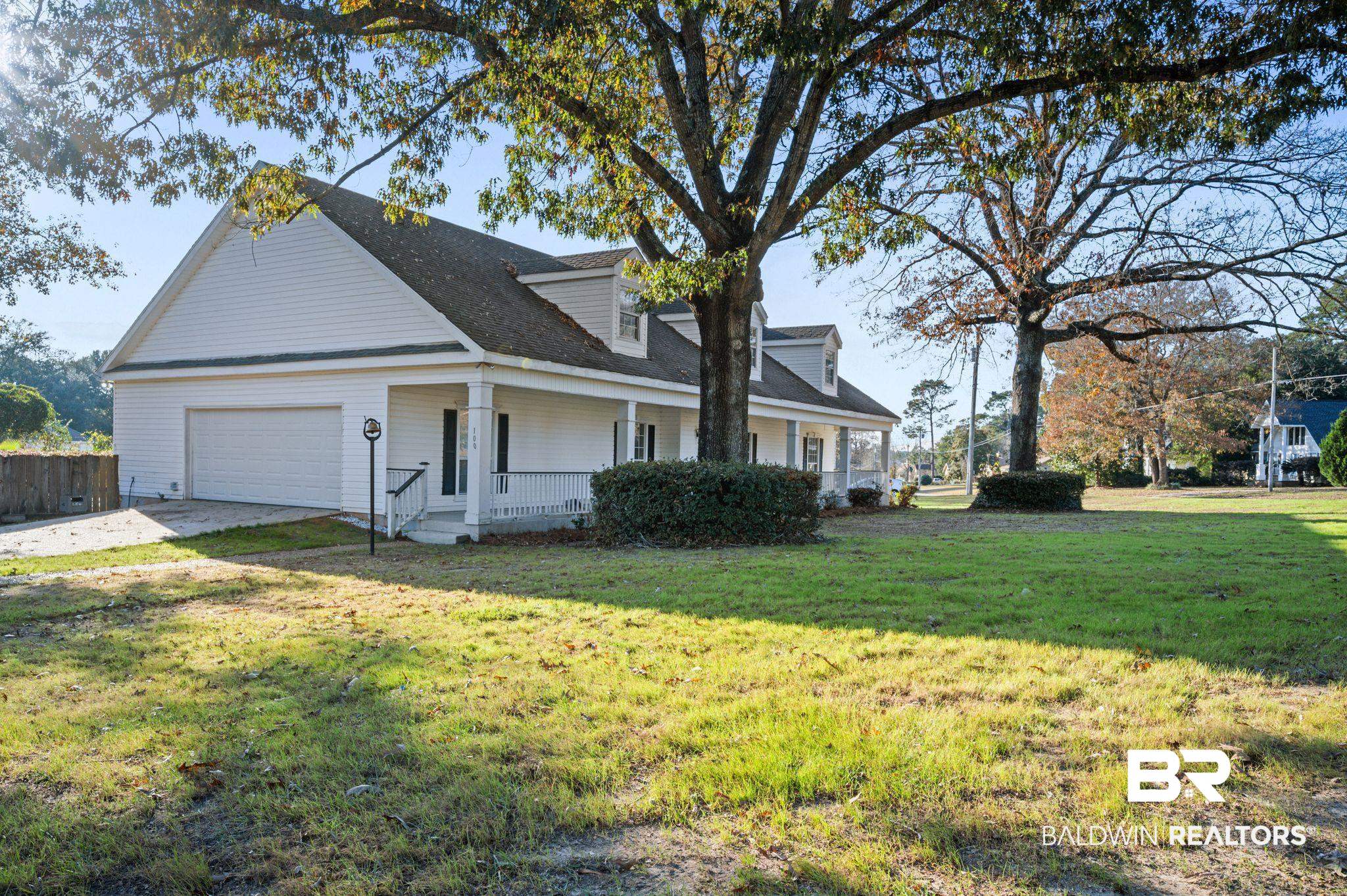 100 Orleans Way Daphne, AL 36526 - Photo 2 of 31 View of side of home featuring covered porch, a yard, and a garage