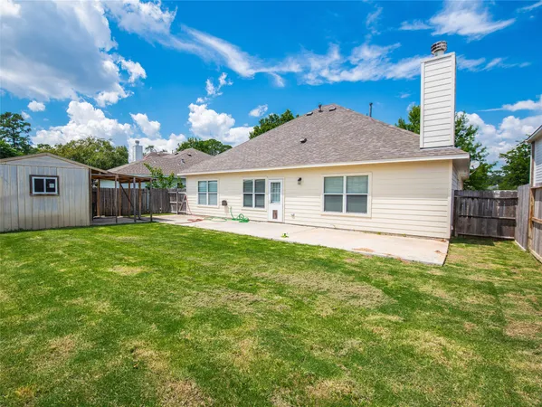 a view of a house with a backyard