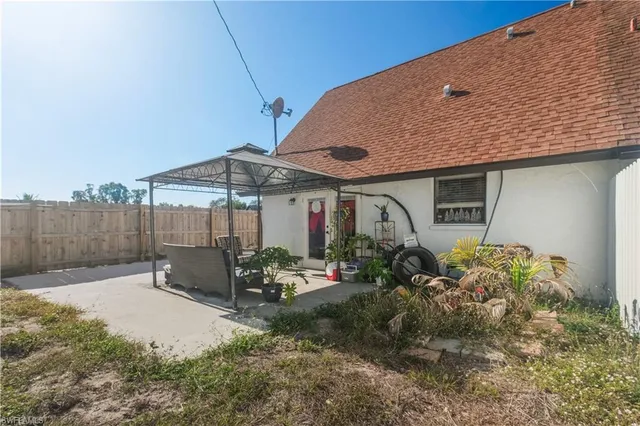 a patio with wooden table and chairs