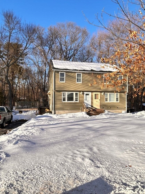 109 Blackstone Street, Unit 109 Bellingham, MA 02019 - Photo 2 of 15 a front view of a house with a yard