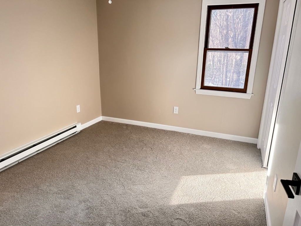 109 Blackstone Street, Unit 109 Bellingham, MA 02019 - Photo 8 of 15 an empty room with windows