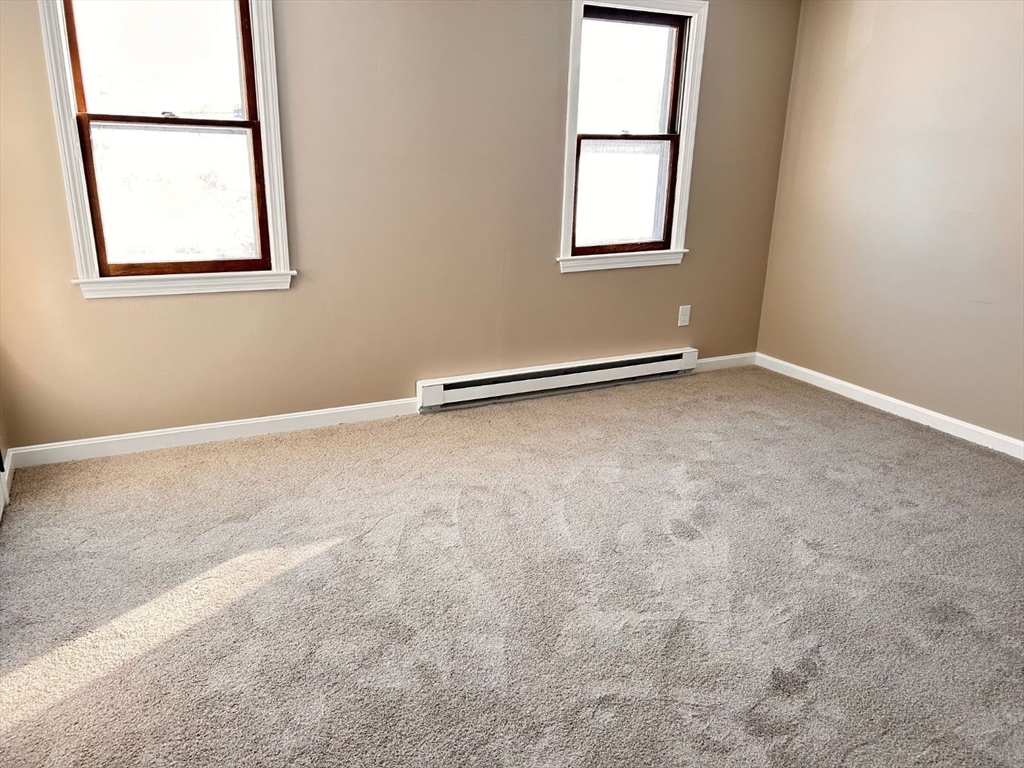 109 Blackstone Street, Unit 109 Bellingham, MA 02019 - Photo 9 of 15 an empty room with windows
