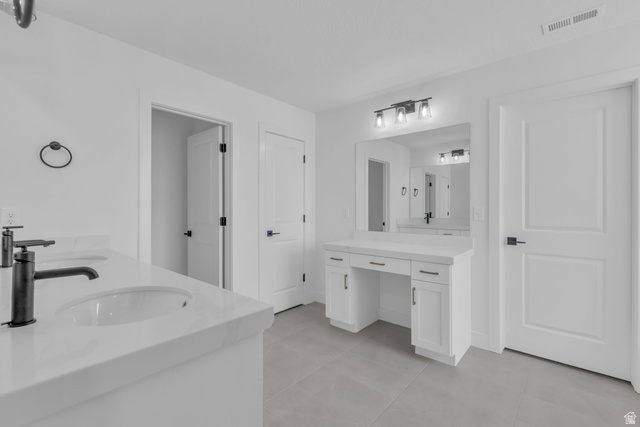 2821 Scarlet Road, Unit 149 Eagle Mountain, UT 84005 - Photo 24 of 28 Spacious primary bathroom #1 featuring dual vanities with white Quartz countertops and matte black faucets, a dedicated makeup vanity with built-in storage, and a large wall-mounted mirror with integrated lighting.